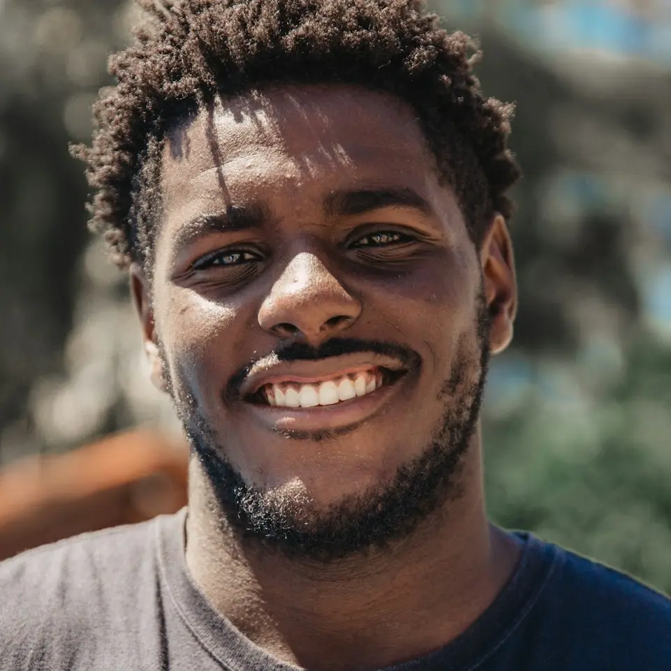 selective focus of man smiling during daytime