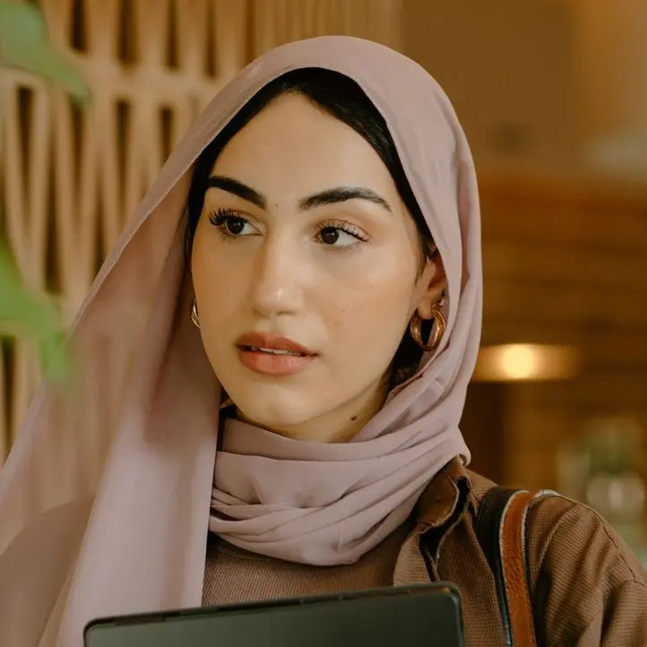 a person holding a laptop